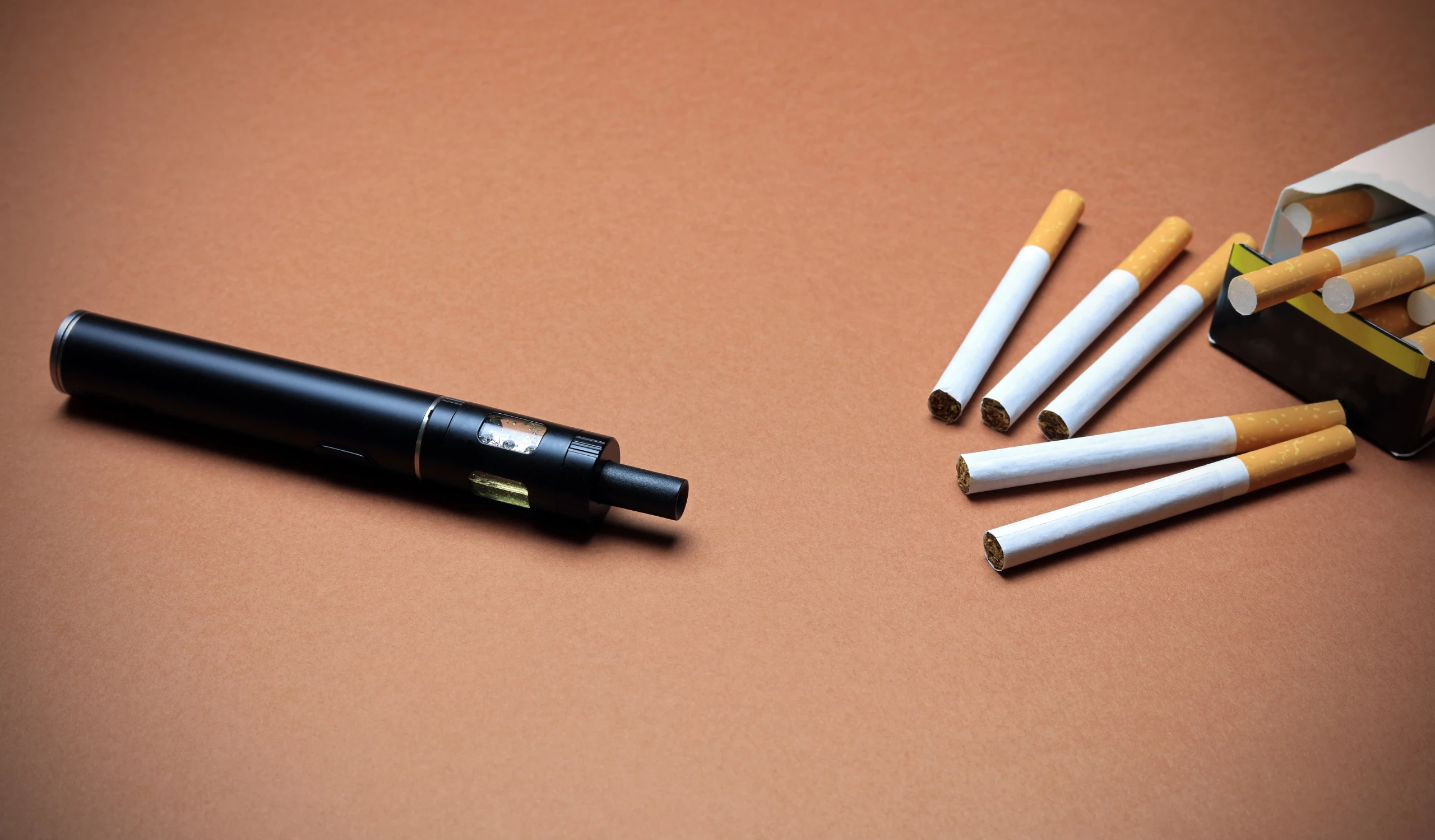 Image of a conventional cigarette and a Heated Product