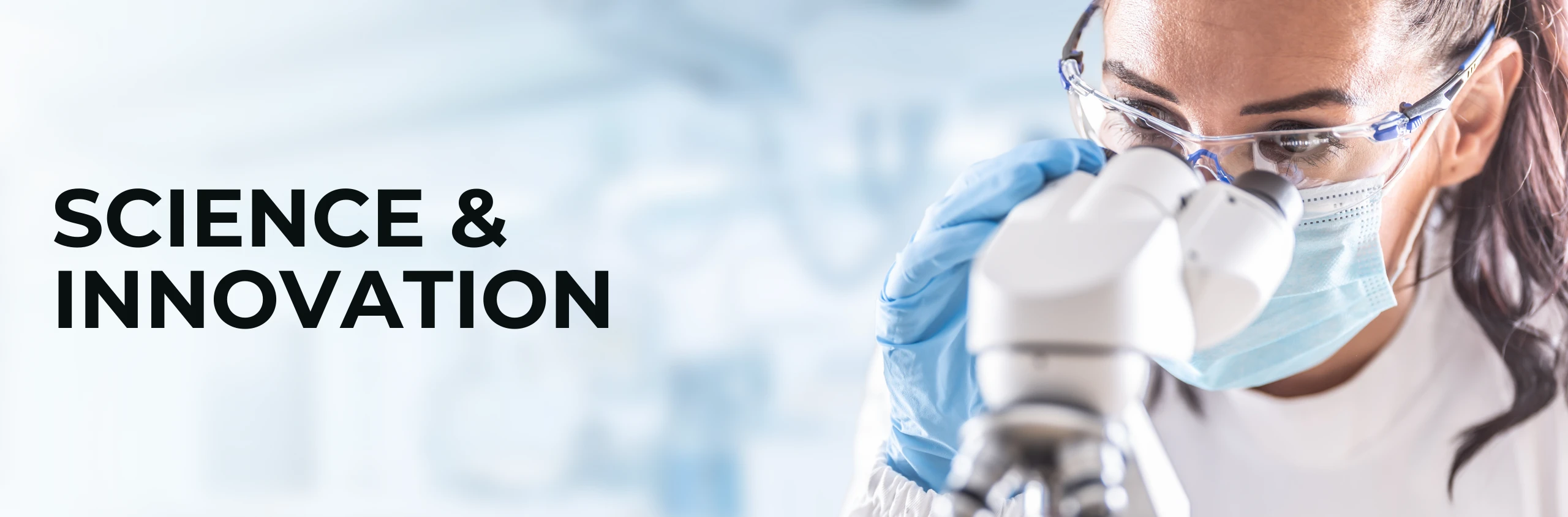 Lab technician examining device prototypes